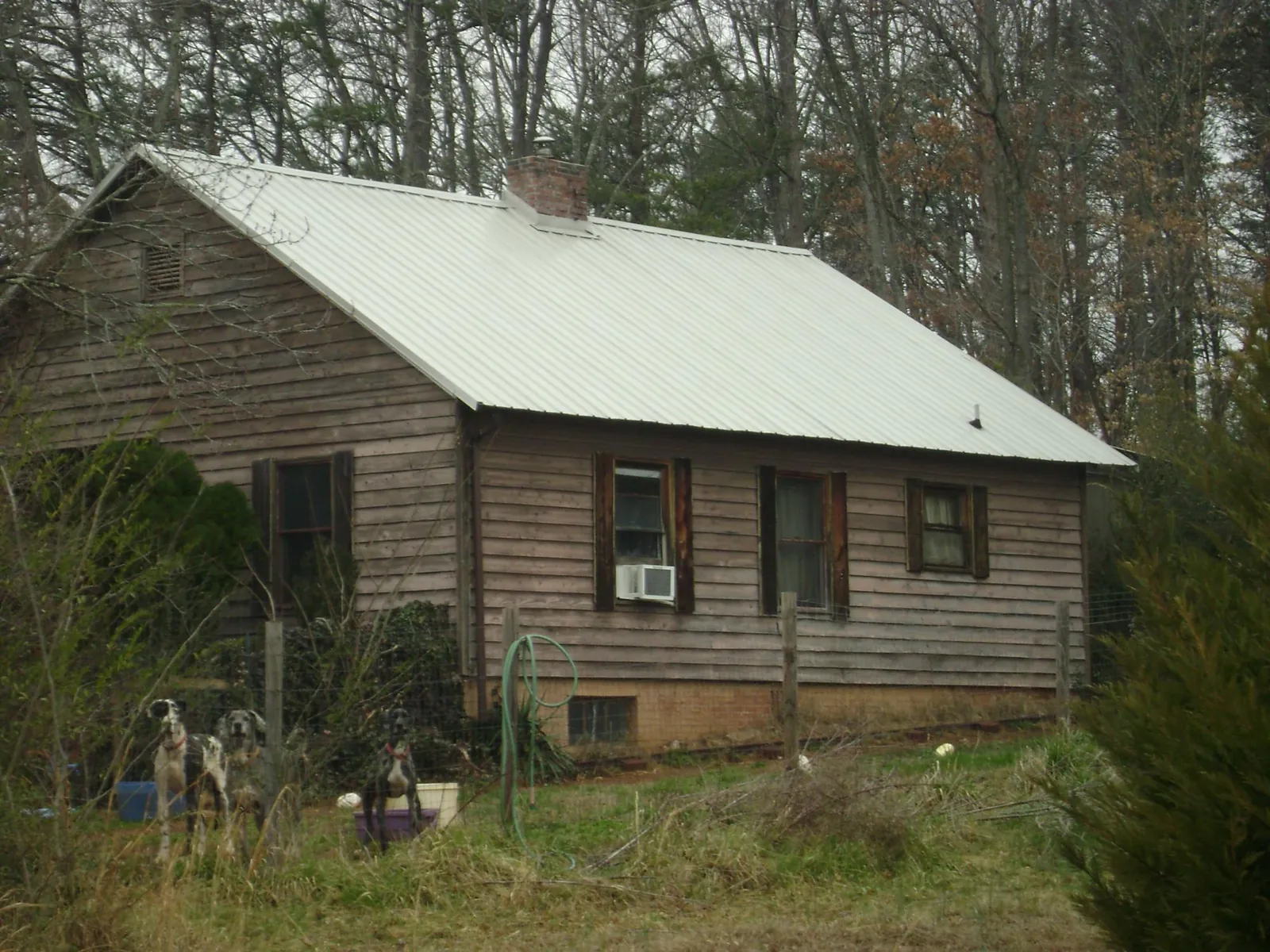 White metal roof on an old wood sided farmhouse, from a Metal Roof Installation job in Ashby